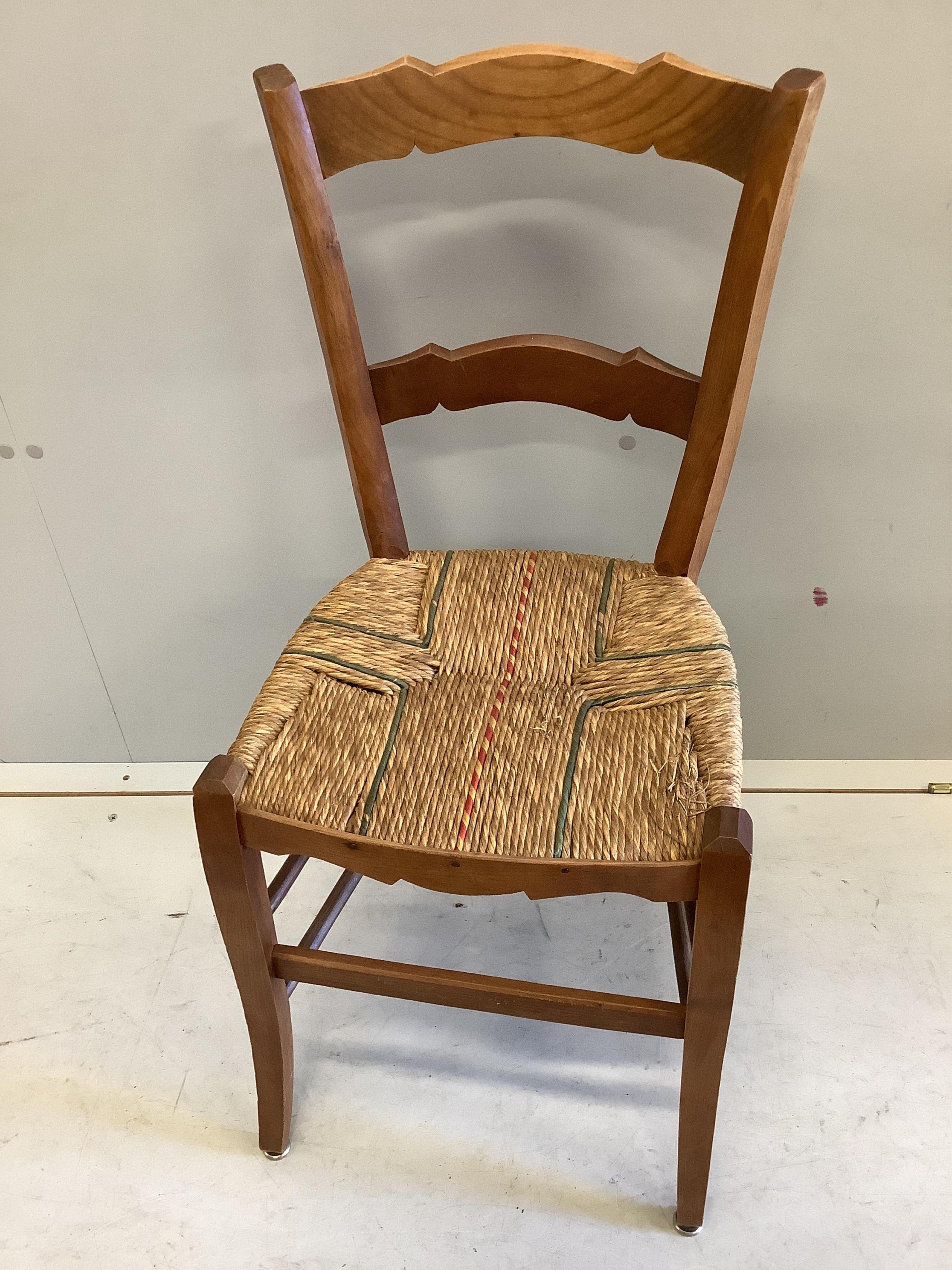 A set of six 19th century French fruitwood kitchen chairs, with rush seats, height 82cm. Condition - fair